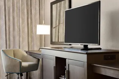 a television on a desk in a hotel room at Hampton Inn Stow in Stow