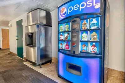 a pepsi machine in a room with a refrigerator at Motel 6-Springfield, OH in Springfield