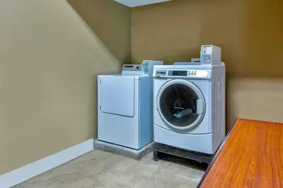 a washer and dryer in a corner of a room at Motel 6-Springfield, OH in Springfield