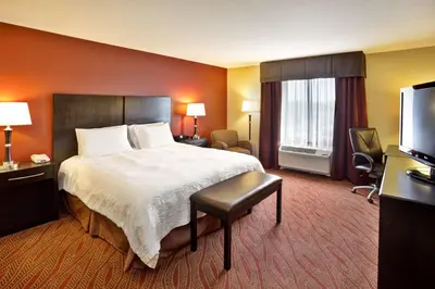a hotel room with a bed and a television at Hampton Inn Ft Wayne in Fort Wayne