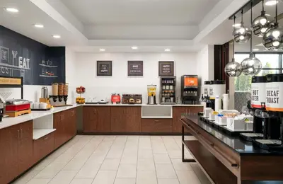 a coffee shop with a counter in the middle at Hampton Inn Ft Wayne in Fort Wayne