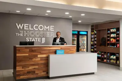 a man standing at a welcome to the hoover store at Hampton Inn Ft Wayne in Fort Wayne
