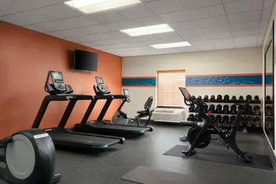 a gym with several tread machines in a room at Hampton Inn Ft Wayne in Fort Wayne