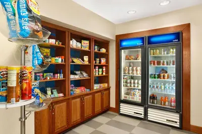 a store room with a refrigerator and shelves with food at Hampton Inn Heath in Heath