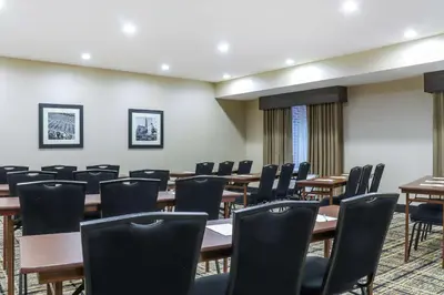 a conference room with wooden tables and chairs at Hampton Inn Heath in Heath