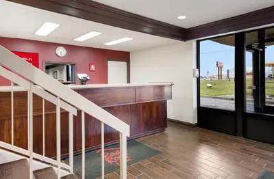 a living room with a staircase and a counter at Red Roof Inn Fort Wayne in Fort Wayne