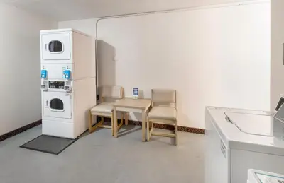 a small room with a table and a washer and dryer at Red Roof Inn Fort Wayne in Fort Wayne
