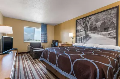 a hotel room with a bed and a tv at Super 8 by Wyndham Medina in Medina