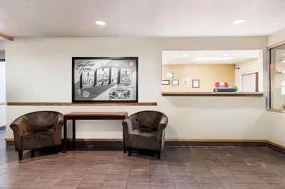 a waiting room with a table and two chairs at Super 8 by Wyndham Medina in Medina