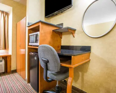 a desk with a chair and a mirror in a room at Quality Inn & Suites North-Polaris in Worthington
