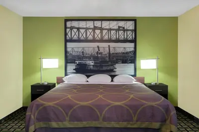 a bedroom with a bed with a view of a bridge at Super 8 by Wyndham Marietta in Marietta