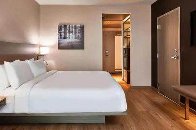 a large white bed in a hotel room at AC Hotel by Marriott Cleveland Beachwood in Beachwood