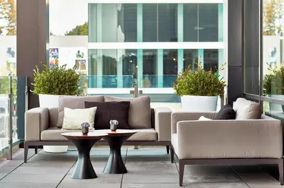 a living room with a couch and a table at AC Hotel by Marriott Cleveland Beachwood in Beachwood
