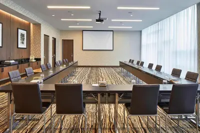 a large conference room with a long table and chairs at AC Hotel by Marriott Cleveland Beachwood in Beachwood