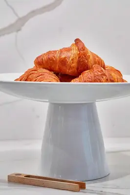 a plate of croissants sitting on top of a table at AC Hotel by Marriott Cleveland Beachwood in Beachwood