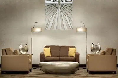 a living room with a couch and two chairs at Radisson Akron-Fairlawn Copley in Fairlawn
