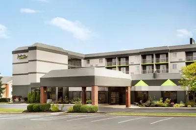 a building with a parking lot in front of it at Radisson Akron-Fairlawn Copley in Fairlawn