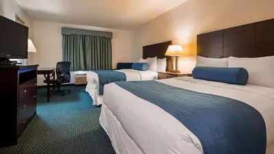 a hotel room with two beds and a flat screen tv at Best Western Gas City in Gas City