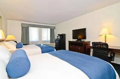 a hotel room with two beds and a flat screen tv at Best Western Gas City in Gas City