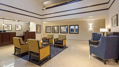 a waiting room at a hospital with chairs and a table at Best Western Gas City in Gas City