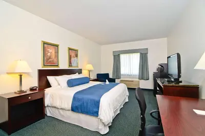 a hotel room with a bed and a flat screen tv at Best Western Gas City in Gas City