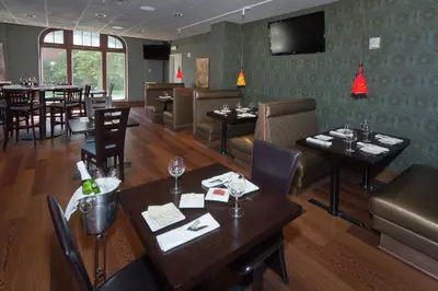 a restaurant with tables and chairs and a dining room at The Tudor Arms Hotel Cleveland - a DoubleTree by Hilton in Cleveland