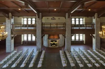 an empty hall with chairs and a fireplace at The Tudor Arms Hotel Cleveland - a DoubleTree by Hilton in Cleveland