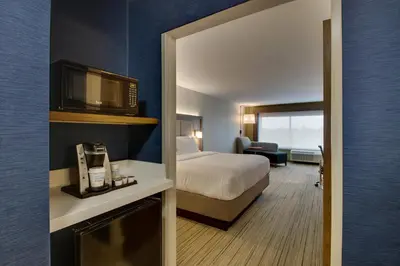 a hotel room with a bed and a microwave at Holiday Inn Express & Suites Mt Sterling North by IHG in Mount Sterling