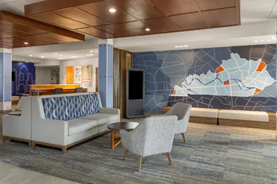 a lobby with a couch and chairs and a mural at Holiday Inn Express & Suites Mt Sterling North by IHG in Mount Sterling