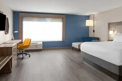 a hotel room with a bed and a desk and a tv at Holiday Inn Express & Suites Mt Sterling North by IHG in Mount Sterling