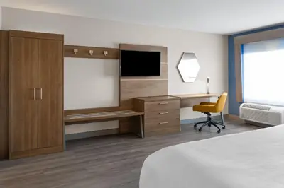 a hotel room with a bed and a desk and a television at Holiday Inn Express & Suites Mt Sterling North by IHG in Mount Sterling