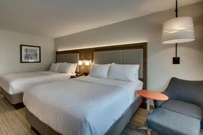 a hotel room with two beds and a chair at Holiday Inn Express & Suites Mt Sterling North by IHG in Mount Sterling