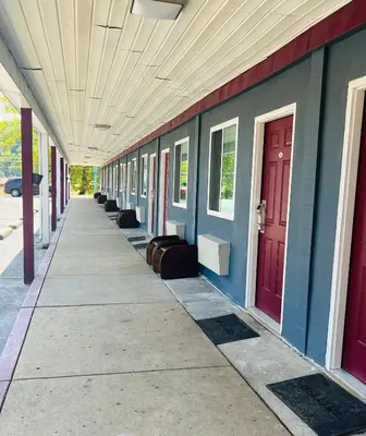 an empty hallway of a building with red doors at Highlander Motel in Athens