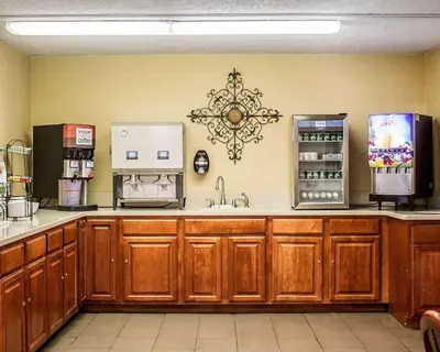 a large kitchen with a sink and a refrigerator at Quality Inn Lima Northeast in Lima