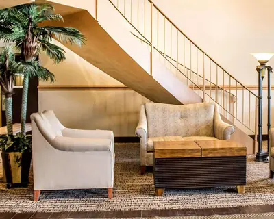 a living room with two chairs and a table at Quality Inn Lima Northeast in Lima