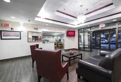 a waiting room with couches and a table and chairs at Red Roof Inn Columbus - Hebron in Hebron