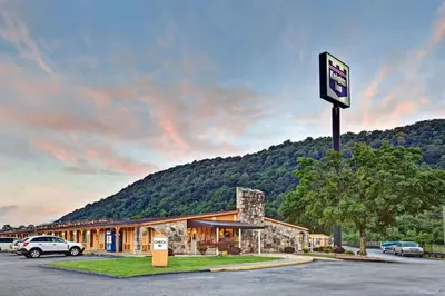 a sign in front of a building with a mountain at Knights Inn Charleston West Virginia in Charleston