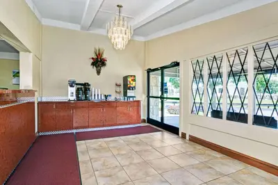 a lobby with a bar with a chandelier at Knights Inn Charleston West Virginia in Charleston