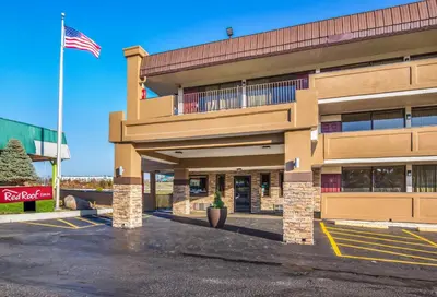 a building with an american flag in a parking lot at Red Roof Inn Cincinnati Airport–Florence/ Erlanger in Erlanger