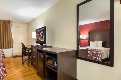 a hotel room with a bed and a mirror at Red Roof Inn Cincinnati Airport–Florence/ Erlanger in Erlanger
