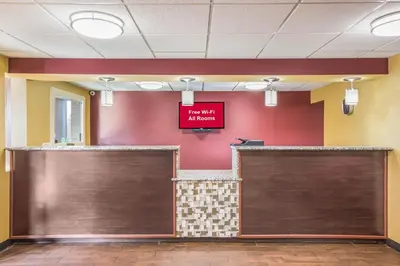 a lobby with two garage doors and a sign on the wall at Red Roof Inn Cincinnati Airport–Florence/ Erlanger in Erlanger