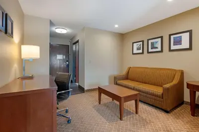 a hotel room with a couch and a table at Comfort Inn Pickerington - Columbus East in Pickerington