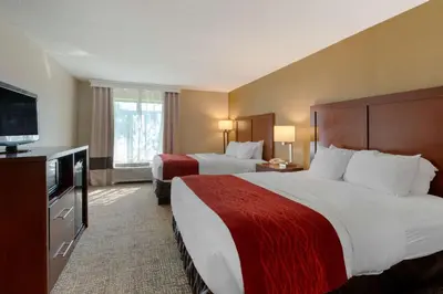 a hotel room with two beds and a flat screen tv at Comfort Inn Pickerington - Columbus East in Pickerington