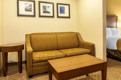 a hotel room with a couch and a bed at Comfort Inn Pickerington - Columbus East in Pickerington