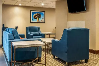 a waiting room with blue chairs and a flat screen tv at Comfort Inn Pickerington - Columbus East in Pickerington