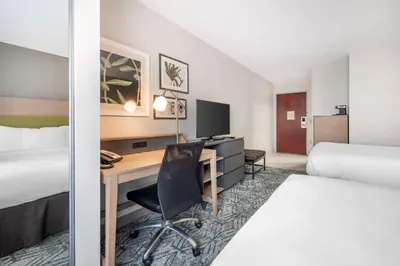 a hotel room with a desk and a bed at Country Inn & Suites by Radisson, Dayton South, OH in Dayton