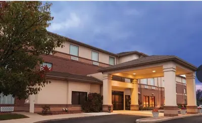 a large brick building with a building at Country Inn & Suites by Radisson, Dayton South, OH in Dayton