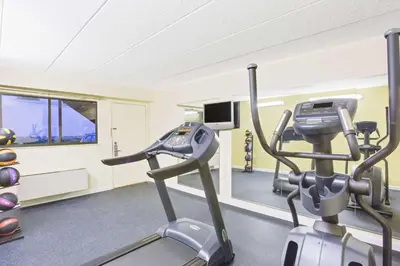 a gym with two exercise bikes in a room at Days Inn by Wyndham Athens in Athens