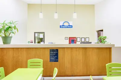 a waiting room at a dog clinic with tables and chairs at Days Inn by Wyndham Athens in Athens