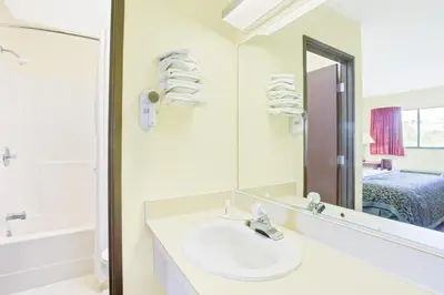 a bathroom with a sink and a mirror at Days Inn by Wyndham Athens in Athens